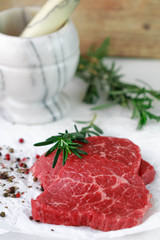 Raw beef chops with spices and rosemary