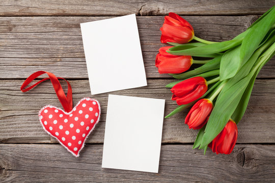 Red tulips, blank photo frames and heart