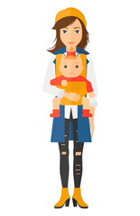 Woman holding baby in sling.
