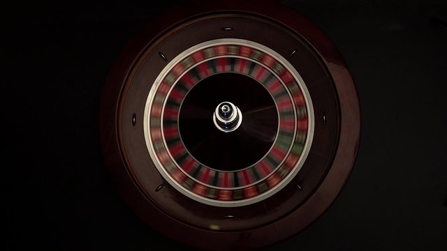 Croupier spins the roulette then stops black