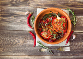 Stuffed red peppers with spicy tomato sauce and rosemary