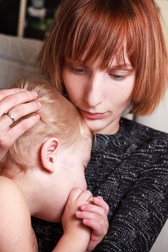 Mother cuddles her son