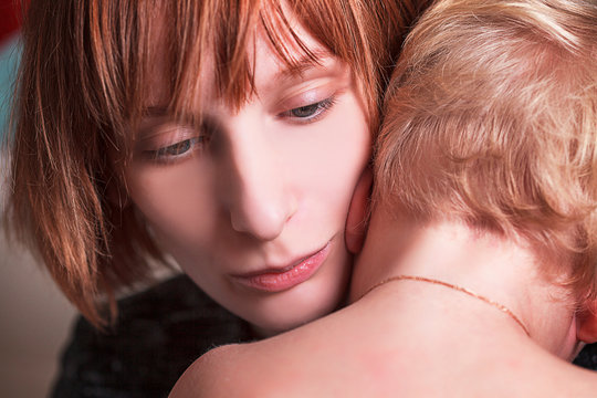 Mother cuddles her son