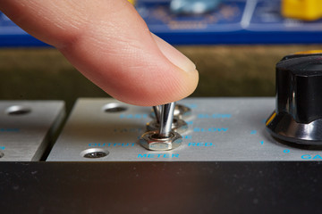 Man is turning a switch with his finer