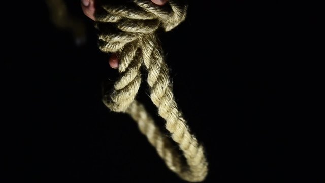 Man tying a noose. suicide, depressed man, gallows noose around his neck
