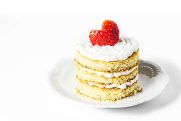 Sponge cake with cream and strawberries for Valentines day. Selective focus.
