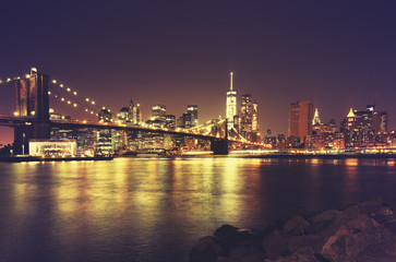 Fototapeta na wymiar Retro toned New York waterfront at night, USA.