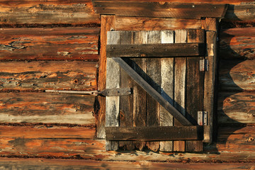 .Closed window in the log wall