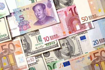Fototapeta na wymiar Dollars, Euro and Yuan banknotes background
