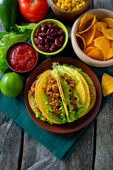 plate of tacos, nachos and tomato dip