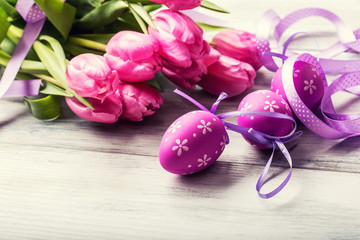 Happy easter. Multicolored spring tulips and Easter eggs. Spring and Easter decorations.