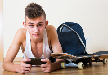 Teenager burying in mobile phone