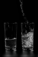 at two glass clean water is poured