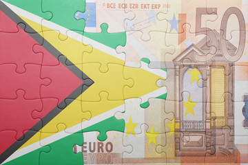 puzzle with the national flag of guyana and euro banknote