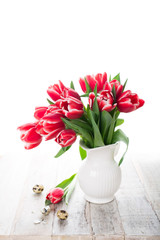 Fototapeta na wymiar Bouquet of pink tulips in vase on the white background