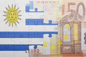 puzzle with the national flag of uruguay and euro banknote