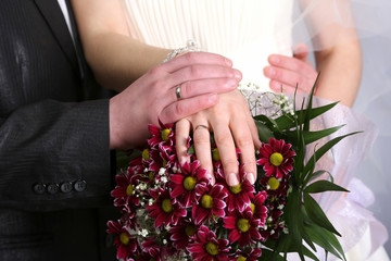 the hands of the bride and bridesmaid wedding bouquet