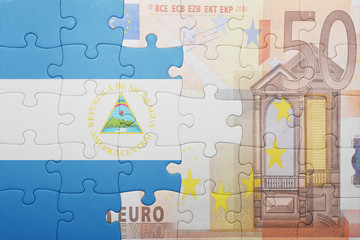 puzzle with the national flag of nicaragua and euro banknote