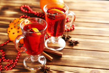 Mulled wine in glass on brown wooden table