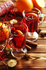 Mulled wine in glass on brown wooden table