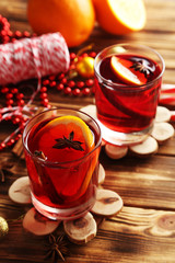 Mulled wine in glass on brown wooden table
