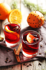 Mulled wine in glass on grey wooden table