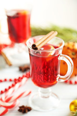Mulled wine in glass on white wooden table