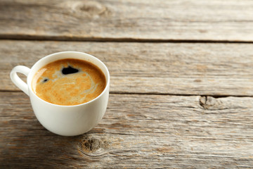 Cup of coffee on a grey wooden table