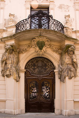 Beautiful baroque style entrance with an iron balcony and arch