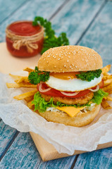 Home made burger on wooden background