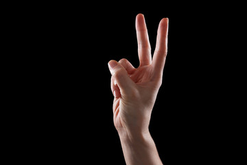 Gesture, young woman's hand indicates the direction or touch devices