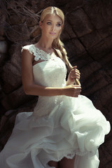 Fototapeta na wymiar Beautiful blonde girl in wedding dress.