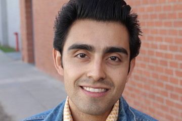 Obraz premium Portrait of a young Hispanic male smiling