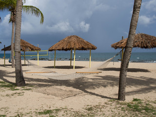 Hammock, Tiki Huts, and Volleyball Net on the Beach