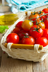Fresh cherry tomatoes on wooden table. Ingredients for tomato sauce