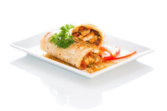 Vegetable and Chicken Wrap Sandwich on a plate stuffed with red peppers and onion