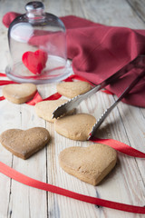 Fototapeta na wymiar Homemade Heart Shape Cookies With Red Ribbon