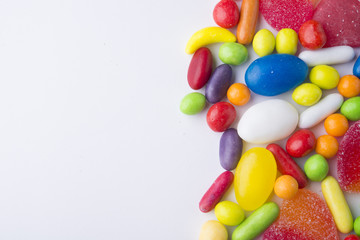 Fototapeta na wymiar Border of colorful jelly candies on white