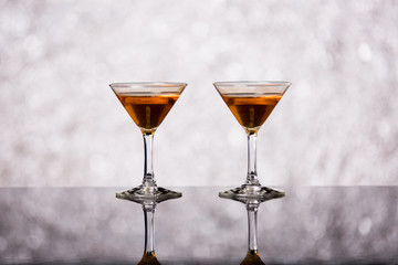Evening drink. glasses with red liqueur on bokeh background