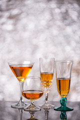 Evening drink. glasses with red liqueur on bokeh background