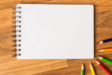 Sketch book and color pencil on wood table