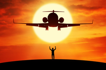 Fototapeta na wymiar Successful businessman standing under flying plane