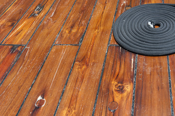 Fototapeta premium Rope on wooden deck of ship