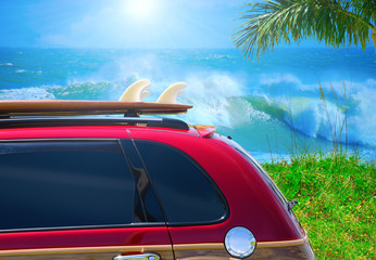 Red station wagon car with surfboard at beach with big waves