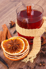 Glass of mulled wine wrapped scarf with fresh fragrant spices