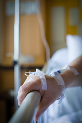 Fototapeta na wymiar Elderly hand in Saline IV drip in hospital emergency room