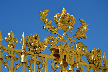 Golden Main Gates of the Versailles Palace. The Palace Versailles was a royal chateau. It was added to the UNESCO list of World Heritage Sites. Paris, France