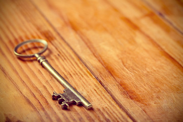 Vintage bronze key placing on wooden table