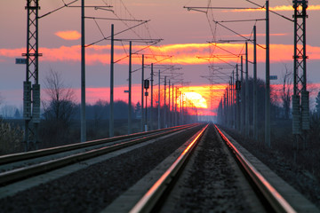 Obraz na płótnie Canvas Railroad - Railway at sunset with sun