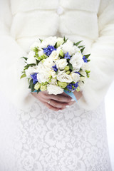 Winter wedding. Bridal bouquet in hands
